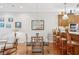 Dining area with glass table and chairs, pendant lighting, and views into the kitchen at 308 S New Jersey Ave # A, Tampa, FL 33609
