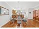 Dining area, showing glass table, chairs, and barstools at the kitchen island at 308 S New Jersey Ave # A, Tampa, FL 33609