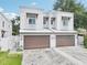 Charming two-story townhome features a private two-car garage and neutral stucco facade with a well-manicured lawn at 308 S New Jersey Ave # A, Tampa, FL 33609
