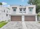 Charming two-story townhome features a private two-car garage and neutral stucco facade with a well-manicured lawn at 308 S New Jersey Ave # A, Tampa, FL 33609