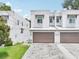 Charming two-story townhome features a private two-car garage and neutral stucco facade with a well-manicured lawn at 308 S New Jersey Ave # A, Tampa, FL 33609
