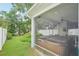 Screened-in lanai featuring a hot tub, TV, and backyard views, perfect for relaxation at 308 S New Jersey Ave # A, Tampa, FL 33609