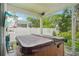 Covered hot tub with TV on a screened-in lanai provides outdoor entertainment space at 308 S New Jersey Ave # A, Tampa, FL 33609