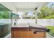 Covered hot tub with TV on a screened-in lanai provides outdoor entertainment space at 308 S New Jersey Ave # A, Tampa, FL 33609