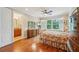 Comfortable main bedroom features hard wood floors, ceiling fan, and ensuite bath at 308 S New Jersey Ave # A, Tampa, FL 33609