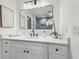 Modern bathroom with a white vanity, black hardware, and a large mirror reflecting the shower at 3205 Pleasant Lake Dr, Tampa, FL 33618