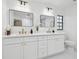 Bright bathroom with a dual sink vanity featuring stone countertops, gold hardware, and modern lighting at 3205 Pleasant Lake Dr, Tampa, FL 33618