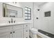 Modern bathroom featuring white vanity with black hardware and a glass-enclosed shower at 3205 Pleasant Lake Dr, Tampa, FL 33618