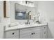Modern bathroom featuring white vanity with black hardware, and a large mirror reflecting the shower at 3205 Pleasant Lake Dr, Tampa, FL 33618