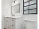 Bright bathroom featuring a white vanity, modern mirror, and a sleek, contemporary design at 3205 Pleasant Lake Dr, Tampa, FL 33618