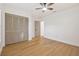 A bright bedroom with wood floors, modern ceiling fan, and a closet with bi-fold doors at 3205 Pleasant Lake Dr, Tampa, FL 33618