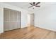 Bright, empty bedroom with light wood floors, ceiling fan, and closet at 3205 Pleasant Lake Dr, Tampa, FL 33618