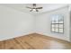 Bright bedroom featuring neutral walls, wood floors, a modern ceiling fan and a window with natural light at 3205 Pleasant Lake Dr, Tampa, FL 33618