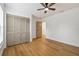 Bright bedroom featuring wood floors, modern ceiling fan and a closet with bi-fold doors at 3205 Pleasant Lake Dr, Tampa, FL 33618