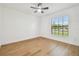 A bright, airy bedroom with modern ceiling fan, wood floors, and a window offering natural light at 3205 Pleasant Lake Dr, Tampa, FL 33618