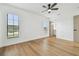 Spacious bedroom with wood floors, bright windows, and a ceiling fan for added comfort at 3205 Pleasant Lake Dr, Tampa, FL 33618