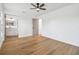 Bedroom featuring wood floors, with an open door to the bathroom at 3205 Pleasant Lake Dr, Tampa, FL 33618