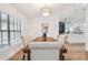 Bright dining room boasts modern light fixture and elegant upholstered chairs at 3205 Pleasant Lake Dr, Tampa, FL 33618