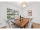 Dining room features wood floors, neutral decor, and natural light from the window at 3205 Pleasant Lake Dr, Tampa, FL 33618