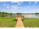 Scenic view of the lake from a wooden dock, perfect for enjoying the outdoors and waterfront living at 3205 Pleasant Lake Dr, Tampa, FL 33618