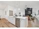 Open concept kitchen flows to living room with stainless appliances and white cabinets at 3205 Pleasant Lake Dr, Tampa, FL 33618