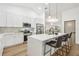 Modern kitchen with white cabinets, island seating, and stainless steel appliances at 3205 Pleasant Lake Dr, Tampa, FL 33618
