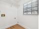 Laundry room with light wood floors, window with blinds and wire shelving at 3205 Pleasant Lake Dr, Tampa, FL 33618