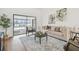 Bright living room with stylish decor and view of screened-in lanai and pool at 3205 Pleasant Lake Dr, Tampa, FL 33618