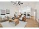 Open concept living room featuring modern decor, wood flooring and view into the kitchen at 3205 Pleasant Lake Dr, Tampa, FL 33618