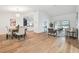 Open concept living area with wood flooring, high ceilings, and views of the pool at 3205 Pleasant Lake Dr, Tampa, FL 33618