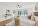 Primary bedroom featuring a king bed, wood floors, ceiling fan, side tables and a view of the pool at 3205 Pleasant Lake Dr, Tampa, FL 33618