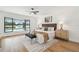 Lake view from this primary bedroom with a king size bed, ceiling fan and bedside tables at 3205 Pleasant Lake Dr, Tampa, FL 33618