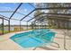 Screened pool area overlooking the lake; a perfect spot for relaxation and enjoying nature's beauty at 3205 Pleasant Lake Dr, Tampa, FL 33618