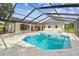 Spacious backyard featuring a screened pool, ideal for outdoor relaxation and entertaining guests at 3205 Pleasant Lake Dr, Tampa, FL 33618