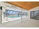 Screened pool with wood-planked ceiling and a clear view of the lake at 3205 Pleasant Lake Dr, Tampa, FL 33618