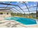 Enclosed pool area with a beautiful view of the lake, featuring a private dock and serene setting at 3205 Pleasant Lake Dr, Tampa, FL 33618