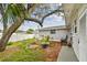 Backyard with brick patio, landscaping, and a well-maintained lawn at 361 Colonial Ct, Dunedin, FL 34698
