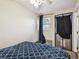 Comfortable bedroom featuring a bed with unique patterned bedding and a ceiling fan for air circulation at 361 Colonial Ct, Dunedin, FL 34698