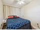 Comfortable bedroom featuring a bed with unique patterned bedding and a ceiling fan for air circulation at 361 Colonial Ct, Dunedin, FL 34698