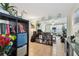 Inviting view into an organized living space with bookshelves, plants, and an open entryway at 361 Colonial Ct, Dunedin, FL 34698