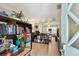 Inviting view into an organized living space with bookshelves, plants, and an open entryway at 361 Colonial Ct, Dunedin, FL 34698
