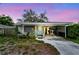 Charming home with a covered carport, front porch, and light blue door at 361 Colonial Ct, Dunedin, FL 34698