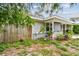 Charming single-story home with a partially covered porch, surrounded by greenery at 361 Colonial Ct, Dunedin, FL 34698