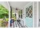 The front porch has a door with windows and a patterned rug at 361 Colonial Ct, Dunedin, FL 34698