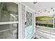 A closer view of the front door with diamond shaped windows and white trim at 361 Colonial Ct, Dunedin, FL 34698
