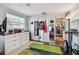 Brightly lit home gym featuring fitness equipment, storage solutions and a mirrored closet at 361 Colonial Ct, Dunedin, FL 34698