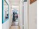 Hallway view leading to a dedicated home gym, offering a convenient fitness space at 361 Colonial Ct, Dunedin, FL 34698