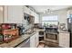 Well-equipped kitchen with stainless steel appliances, ample cabinet space and stylish countertops at 361 Colonial Ct, Dunedin, FL 34698