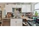 This home features a kitchen with granite counters and stainless appliances at 361 Colonial Ct, Dunedin, FL 34698