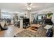 Inviting living room showcasing tile floors, ceiling fan, and an open floor plan to the kitchen at 361 Colonial Ct, Dunedin, FL 34698